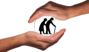 caring hands holding older couple